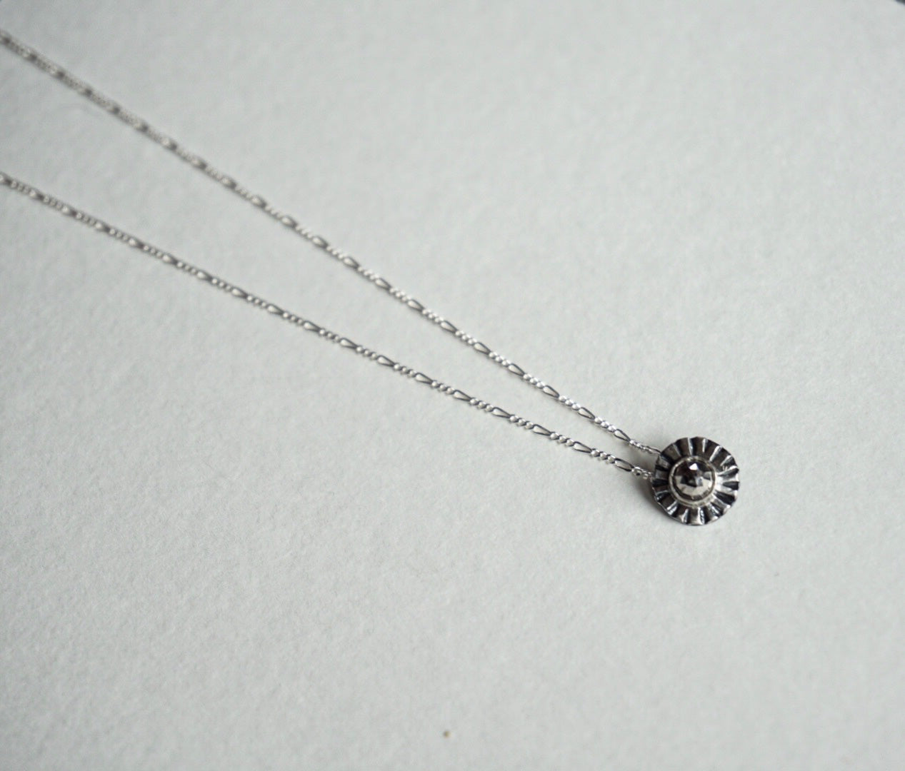 Small sterling silver ridge circle necklace with faceted pyrite