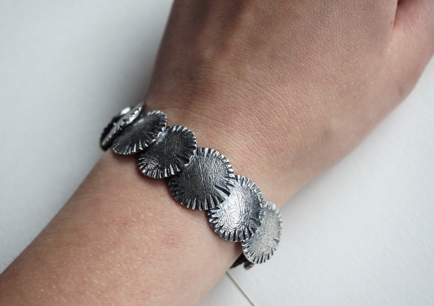 Carved and textured sterling disc bracelet