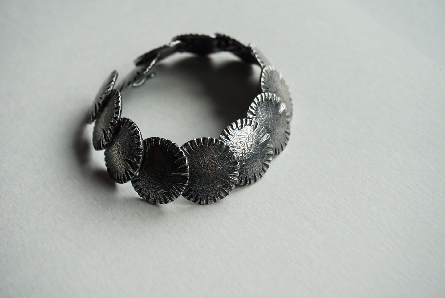 Carved and textured sterling disc bracelet
