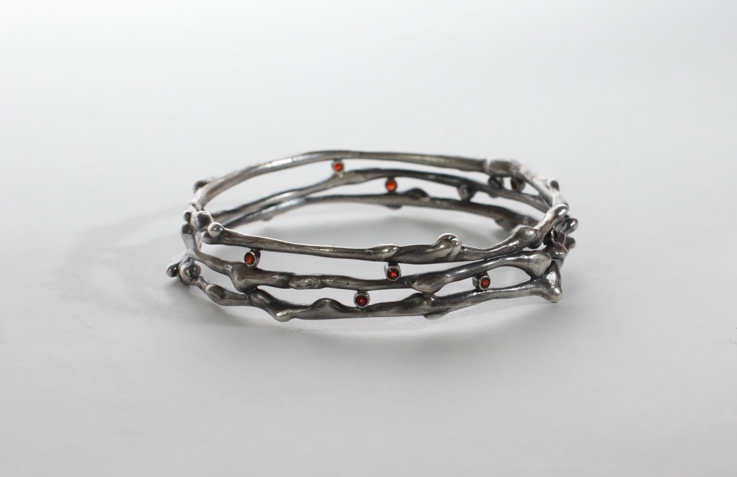 Organic triple banded rhodolite garnet and silver bangle