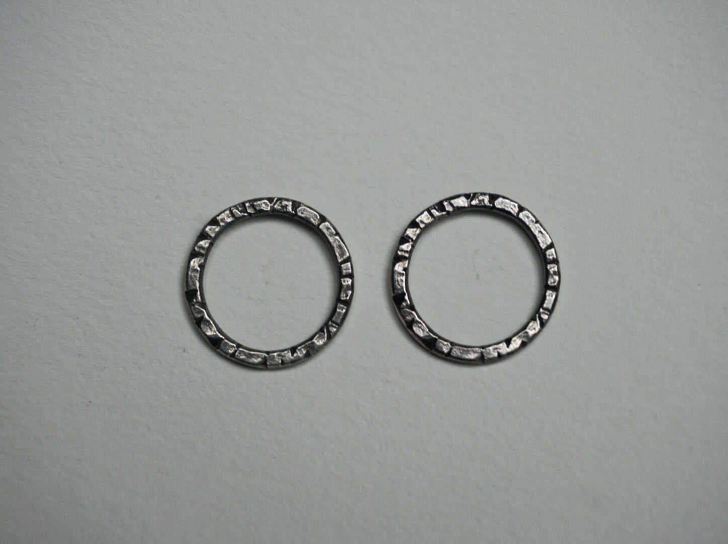 Textured sterling silver stud hoops.