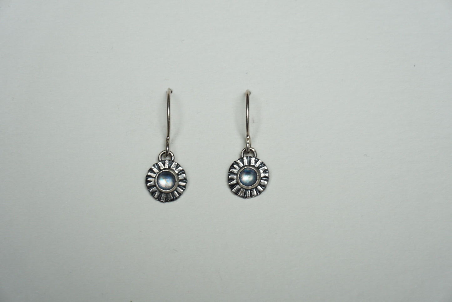 Small silver ridged circle drop earring with moonstone